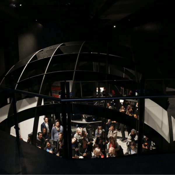 a crowd of people in a dark room